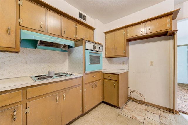 4801 Del Crest Dr, Del City, OK 73115 - kitchen featuring white oven, stainless steel electric cooktop, under cabinet range hood, backsplash, and light countertops