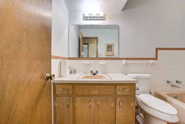 4801 Del Crest Dr, Del City, OK 73115 - bathroom featuring a tub to relax in, vanity, a wainscoted wall, and tile walls