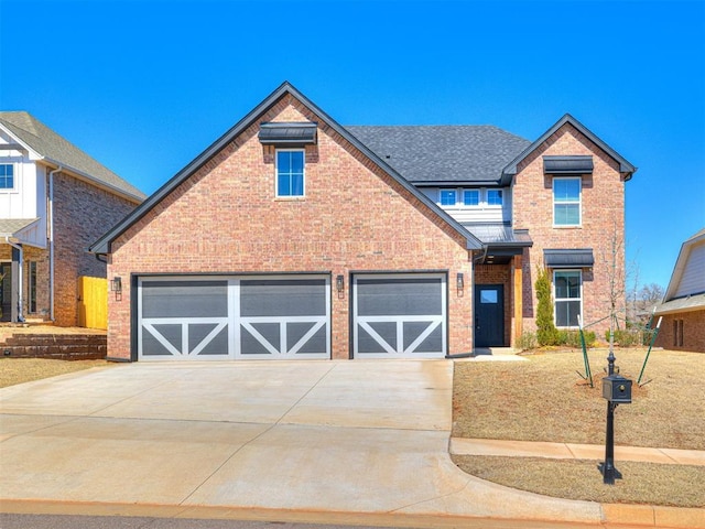 traditional-style home featuring brick siding, concrete driveway, and a shingled roof