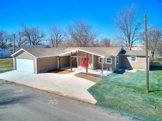 ranch-style home with an attached carport, a front lawn, fence, concrete driveway, and a garage