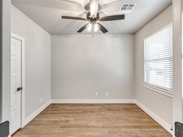 unfurnished room featuring visible vents, baseboards, light wood-type flooring, and ceiling fan