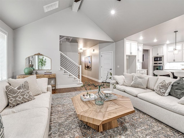 living room featuring visible vents, beam ceiling, wood finished floors, recessed lighting, and stairs