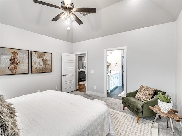 bedroom with ceiling fan, baseboards, vaulted ceiling, carpet flooring, and ensuite bath