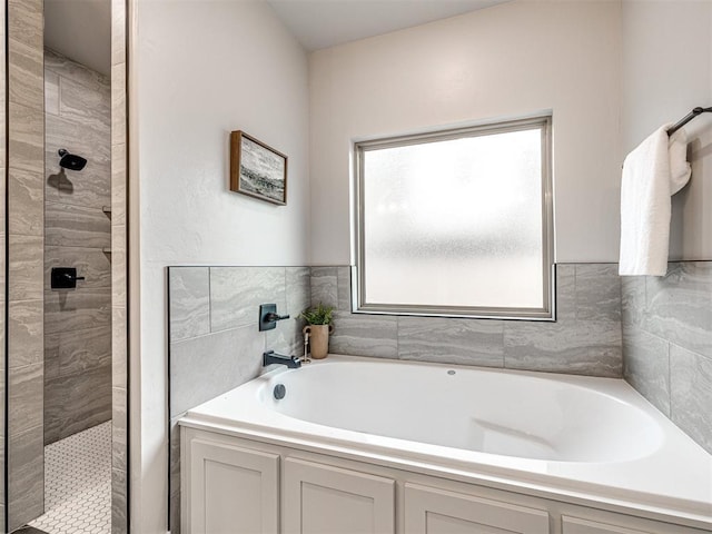 full bathroom featuring a bath and tiled shower