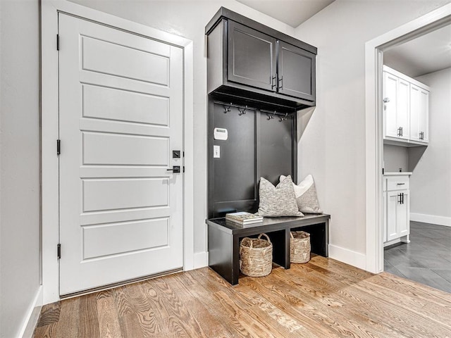 mudroom featuring wood finished floors and baseboards