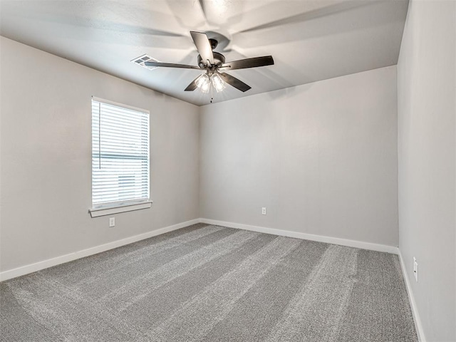 unfurnished room featuring visible vents, carpet flooring, a ceiling fan, and baseboards