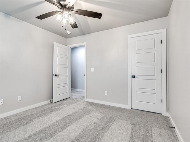 unfurnished bedroom featuring baseboards, carpet, and ceiling fan