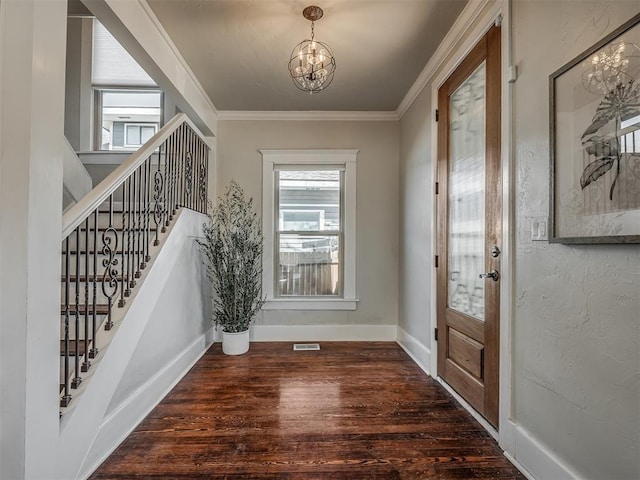 entryway with visible vents, crown molding, stairs, wood finished floors, and a notable chandelier