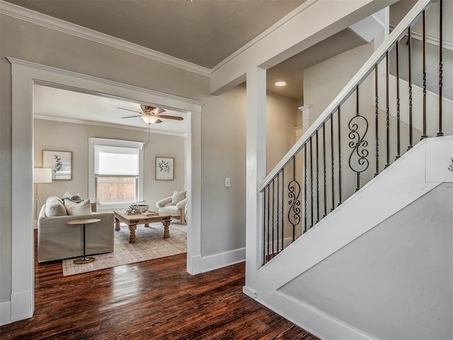 stairs featuring ceiling fan, crown molding, baseboards, and wood finished floors