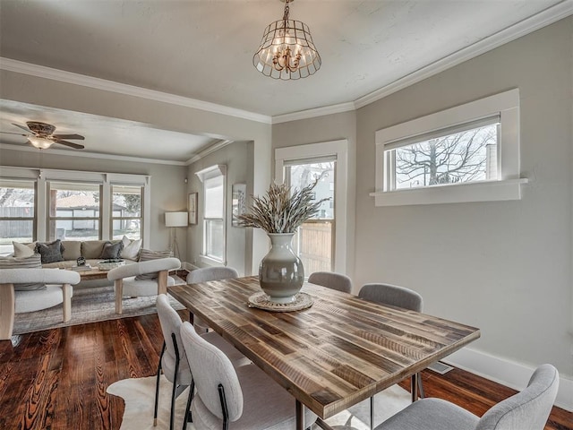 dining room featuring baseboards, ceiling fan with notable chandelier, dark wood-style floors, and ornamental molding