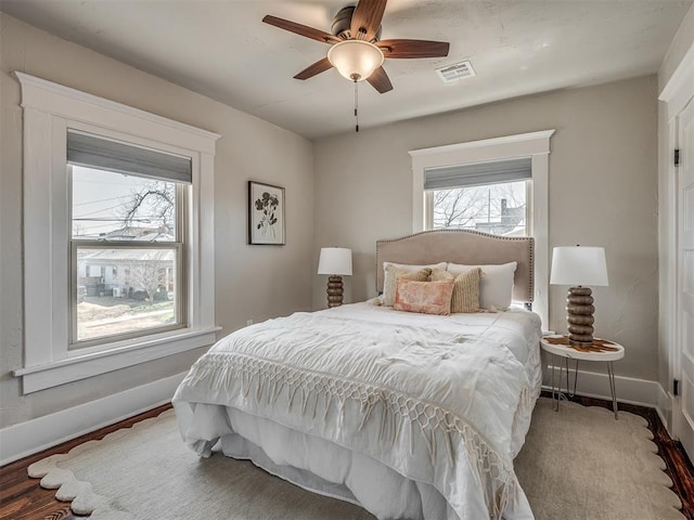 bedroom with visible vents, baseboards, and a ceiling fan