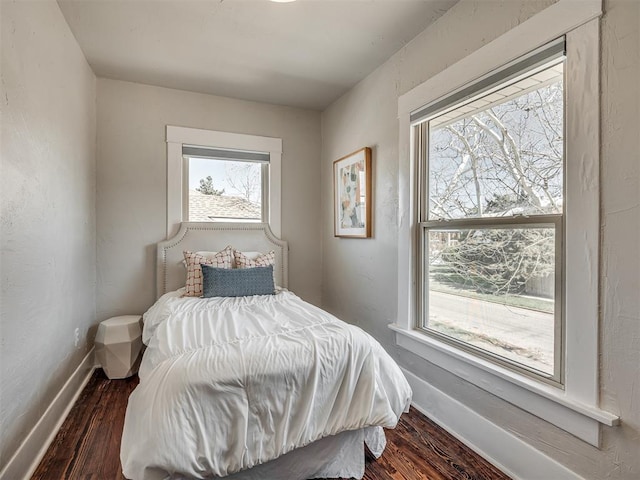 bedroom with baseboards and wood finished floors