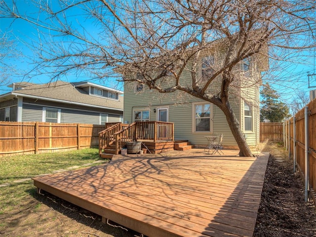 back of house with a wooden deck and a fenced backyard