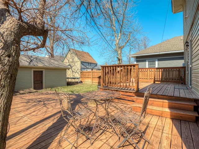 wooden deck featuring a trampoline and fence