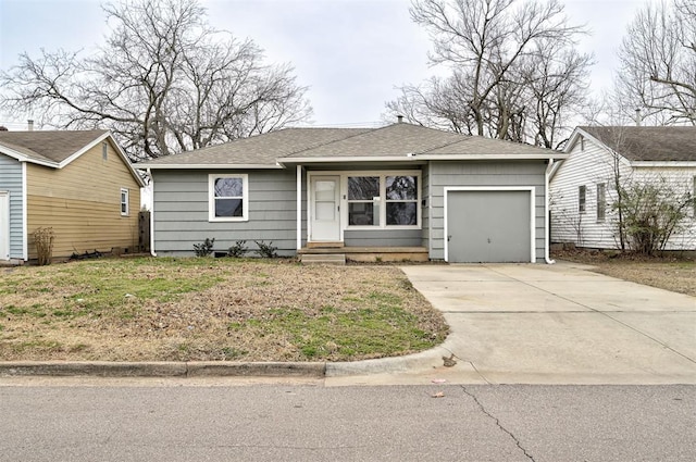 view of front of house featuring an attached garage, driveway, and a shingled roof