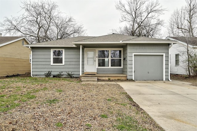 view of front of house featuring roof with shingles, concrete driveway, and an attached garage