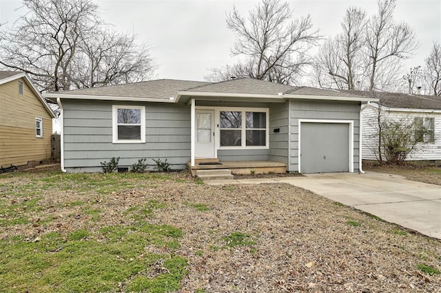 view of front facade featuring entry steps, concrete driveway, a garage, and roof with shingles