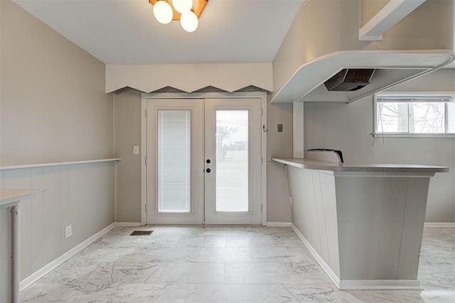 entryway with french doors, baseboards, and marble finish floor