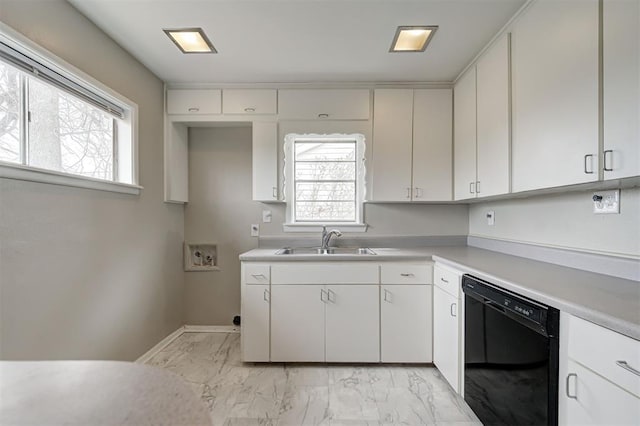 kitchen with light countertops, black dishwasher, marble finish floor, white cabinetry, and a sink