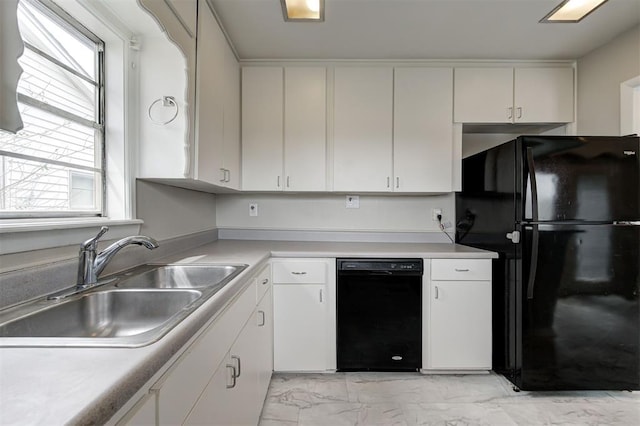 kitchen with black appliances, a healthy amount of sunlight, marble finish floor, and a sink