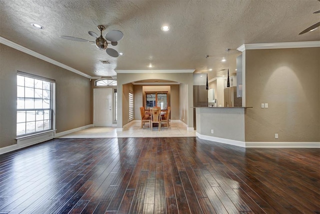 interior space with baseboards, wood-type flooring, and a ceiling fan