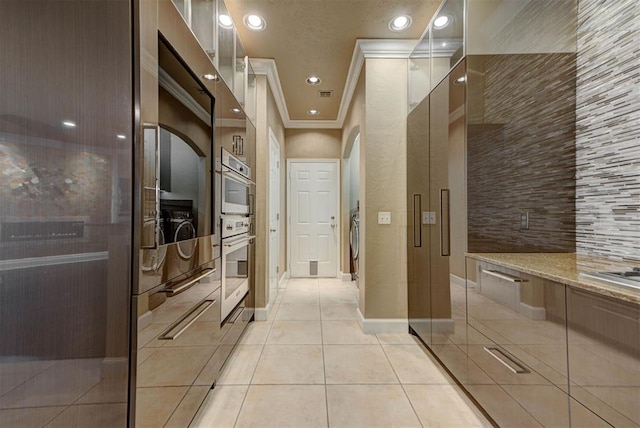 interior space featuring tile patterned flooring, tasteful backsplash, baseboards, ornamental molding, and recessed lighting