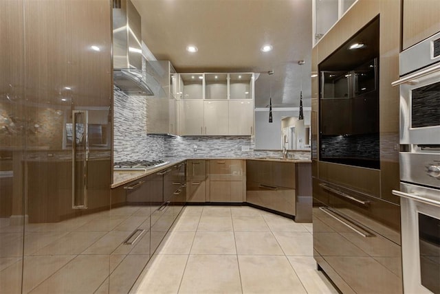 kitchen featuring backsplash, extractor fan, light tile patterned floors, stainless steel gas stovetop, and modern cabinets