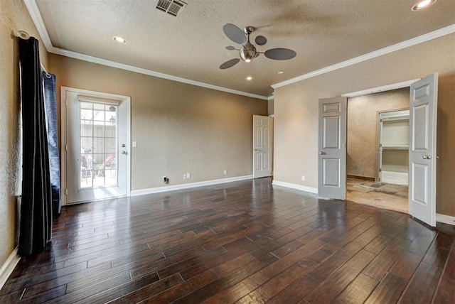 spare room featuring visible vents, a ceiling fan, a textured ceiling, dark wood finished floors, and baseboards