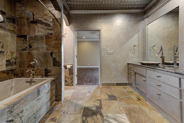 bathroom with stone tile flooring, vanity, tiled shower / bath combo, and ornamental molding