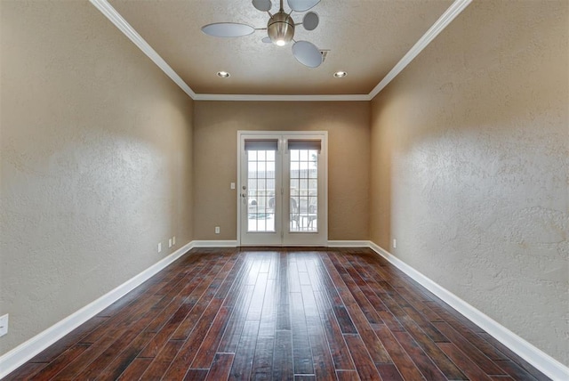 unfurnished room featuring baseboards, dark wood-type flooring, crown molding, a notable chandelier, and a textured wall