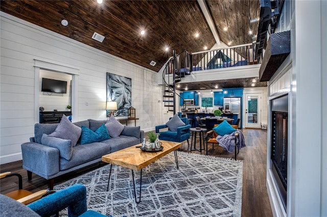 living area featuring baseboards, visible vents, high vaulted ceiling, dark wood-type flooring, and wood ceiling