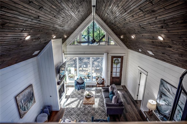 unfurnished living room with dark wood-style floors, wood walls, high vaulted ceiling, and wood ceiling