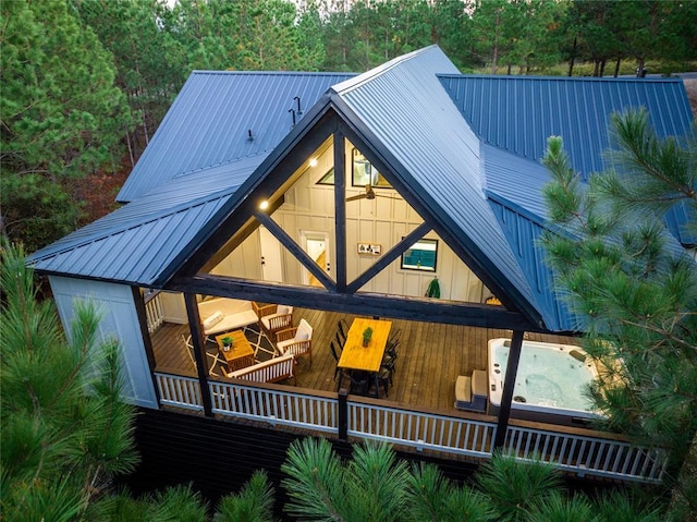 view of front facade with an outdoor hot tub and metal roof