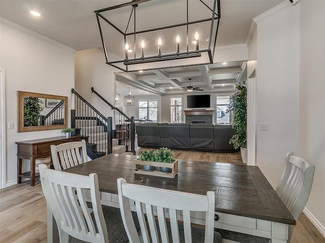 8800 Stark St, Arcadia, OK 73007 - dining area featuring stairway, light wood-type flooring, ceiling fan, ornamental molding, and coffered ceiling