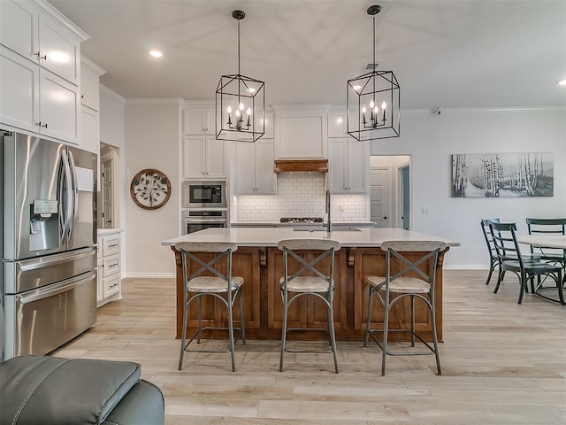 8800 Stark St, Arcadia, OK 73007 - kitchen featuring stainless steel appliances, crown molding, baseboards, a chandelier, and tasteful backsplash