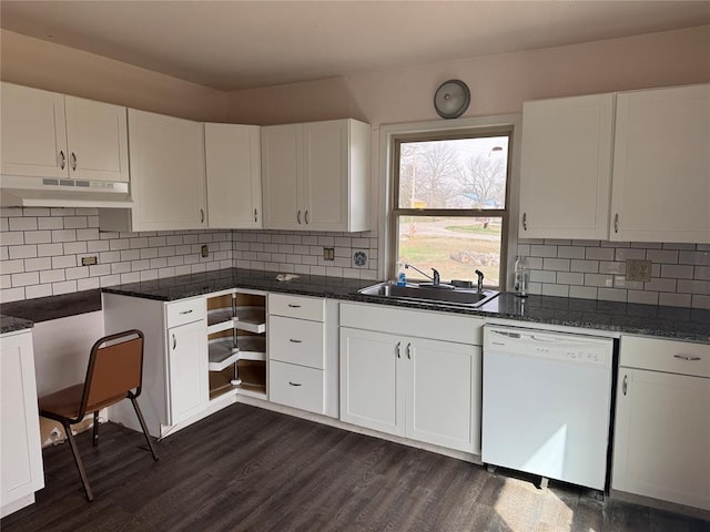 kitchen featuring dark wood finished floors, white dishwasher, a sink, under cabinet range hood, and white cabinetry