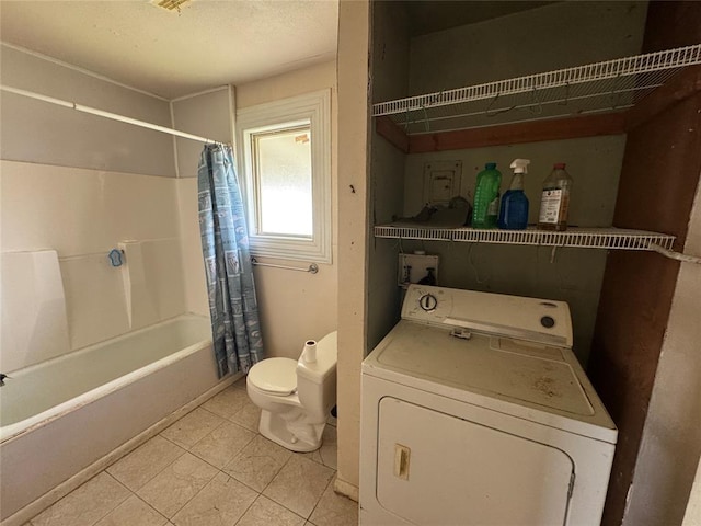 bathroom with washer / dryer, toilet, and shower / bath combo
