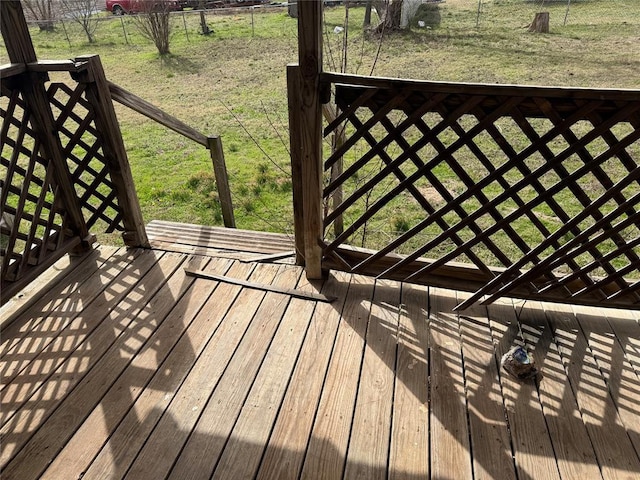 wooden deck with a lawn and fence