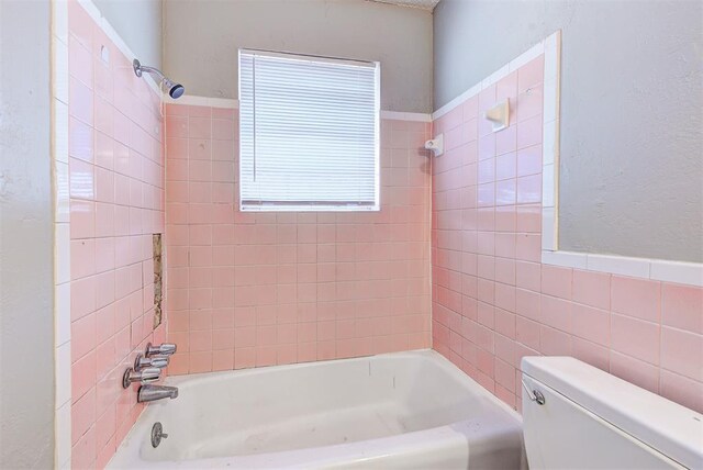 3333 S Walker Ave, Oklahoma City, OK 73109 - bathroom with tile walls, toilet, and shower / bathtub combination
