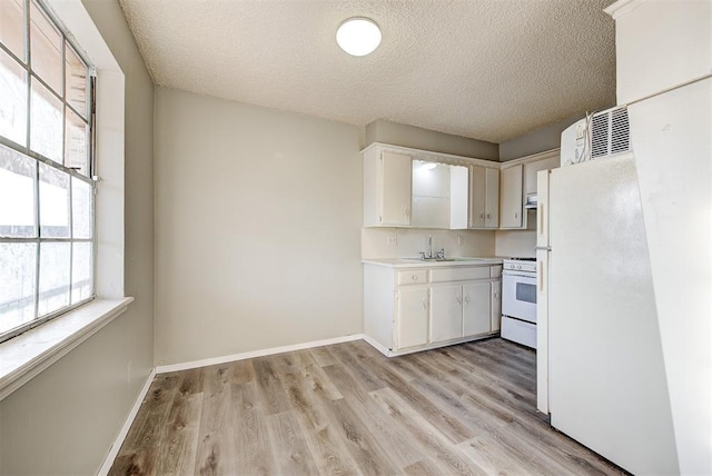 3333 S Walker Ave, Oklahoma City, OK 73109 - kitchen featuring white appliances, light countertops, baseboards, and a sink