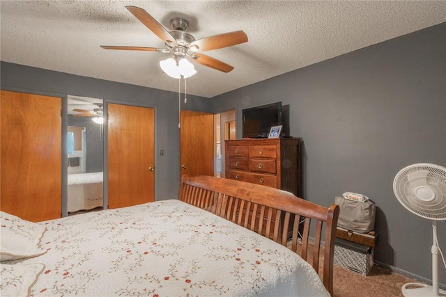 bedroom featuring ceiling fan, carpet, baseboards, and a textured ceiling