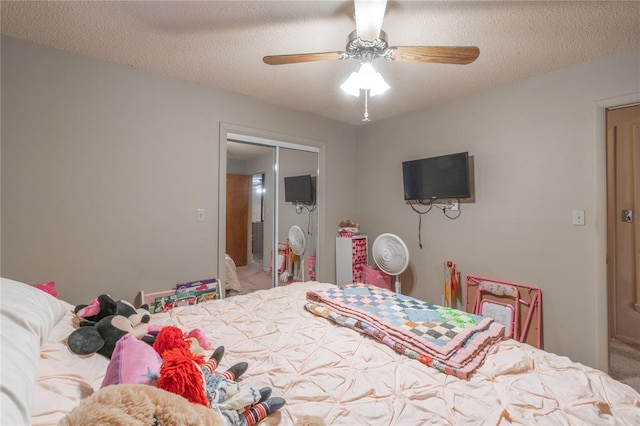 bedroom featuring a ceiling fan and a textured ceiling