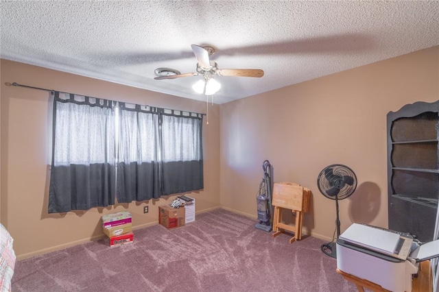 interior space with baseboards, a textured ceiling, and a ceiling fan