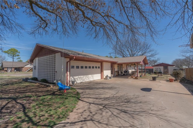 view of front of property featuring brick siding, concrete driveway, a garage, and fence