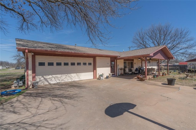 view of front of house featuring concrete driveway, an attached garage, fence, and brick siding