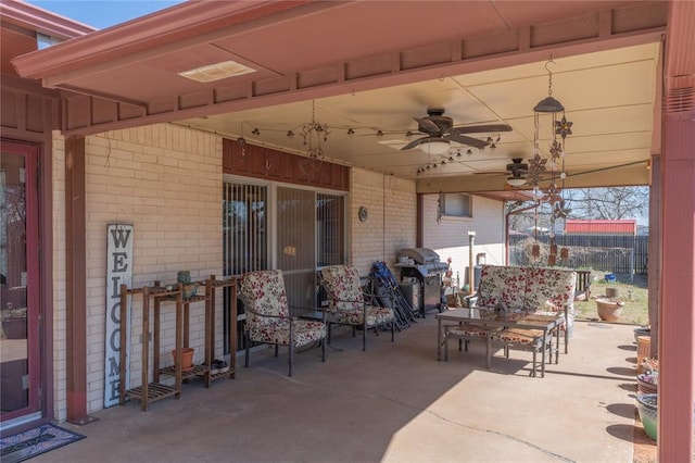 view of patio with area for grilling and ceiling fan