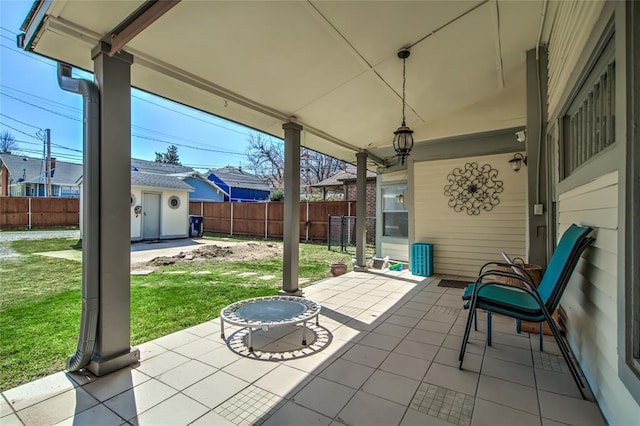 view of patio with an outbuilding and a fenced backyard