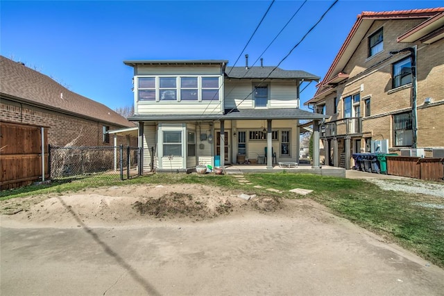 back of house featuring fence and covered porch