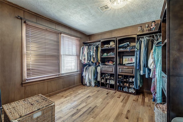 walk in closet with visible vents and wood finished floors