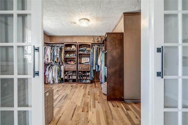 spacious closet with light wood-style floors